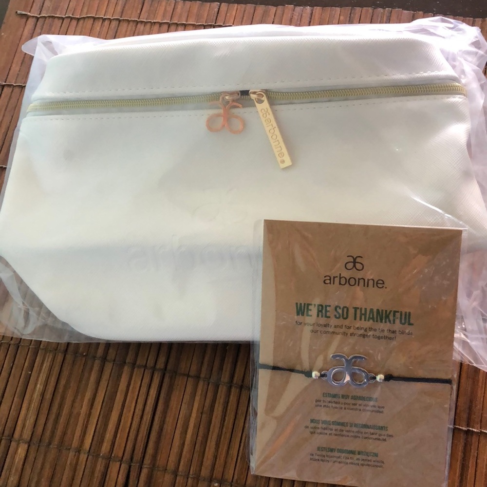 Arbonne White cosmetics bag and bracelet